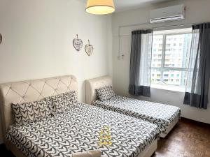 a bedroom with a bed and a window at BayView Suites Port Dickson By MAISON in Port Dickson
