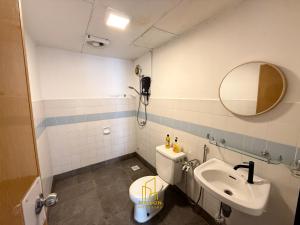 a bathroom with a sink and a toilet and a mirror at BayView Suites Port Dickson By MAISON in Port Dickson +52 photos