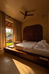 a bedroom with a bed with a ceiling fan at Neem - Boutique Hotel Madiha - ADULTS ONLY in Kamburugamuwa +71 photos