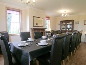 a dining room with a table and chairs at Rascal Wood in Holme upon Spalding Moor