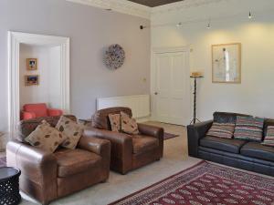 a living room with two couches and a couch at Holly Lodge in Gilcrux
