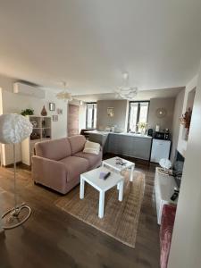 a living room with a couch and a table at L'écrin - Studio Cosy et Lumineux in Andance