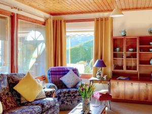 a living room with a couch and a chair at Achnacarry Cottage in Evelix