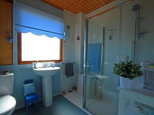 a bathroom with a sink and a shower and a toilet at Achnacarry Cottage in Evelix +7 photos