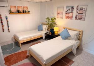 a room with two beds in a room at Bamboo Beach House @ Phang Nga in Thai Muang