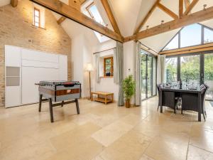 a living room with a ping pong table at New Inn Farmhouse in Marnhull