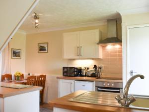 a kitchen with white cabinets and a counter top at Hayloft - Ukc4241 in Lanreath