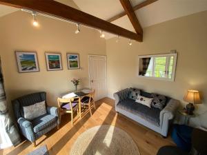 a living room with a couch and a table at Mark Close Milking Parlour in Alston