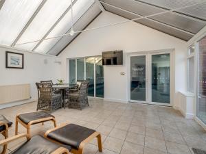 a patio with a table and chairs at The Willows in Sea Palling +15 photos