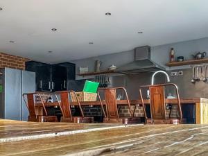 a row of chairs in a room with a table at Hobland Barn in Paston