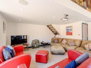 a living room with a couch and a tv at Go Cart Barn in Gloucester