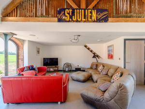 a living room with couches and a red couch at Go Cart Barn in Gloucester
