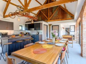 a kitchen and dining room with a wooden table and chairs at Go Cart Barn in Gloucester