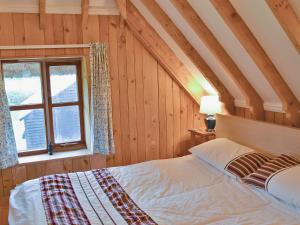 a bedroom with a bed and a window at Walnut Tree Cottage in Burbage +2 photos
