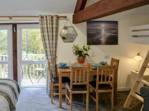 a bedroom with a table and chairs and a bed at Barn Owl Bothy in Westward