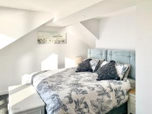 a bedroom with a bed with a blue headboard at Point Clear View in Brightlingsea +12 photos