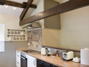 a kitchen with a wooden counter top in a room at Timbessie Barn in Carperby +10 photos