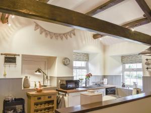 a kitchen with a sink and a counter top at Timbessie Barn in Carperby