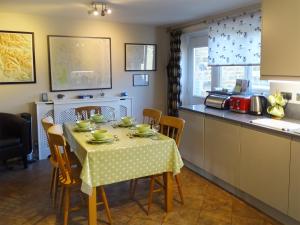 a kitchen with a table with a tablecloth on it at Bank View in Settle