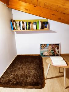 a room with a table and a book shelf at Hostal Restaurante LA SENDA in Camponaraya