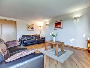 a living room with a couch and a table at 5 Red Rock Apartments in Dawlish Warren