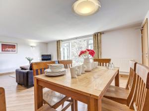 a dining room with a wooden table and chairs at 5 Red Rock Apartments in Dawlish Warren