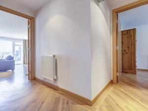 an empty room with a white wall and a door at 4 Red Rock Apartments in Dawlish Warren +10 photos