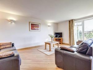 a living room with two couches and a tv at 4 Red Rock Apartments in Dawlish Warren