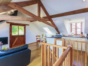 a large kitchen and living room with wooden beams at Cider Barn in Chulmleigh