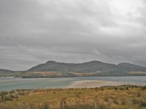 a view of a body of water with mountains in the background at Melness Cottage in Melness