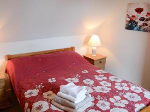 a bedroom with a bed with towels on it at Melness Cottage in Melness