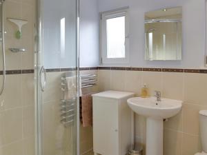 a bathroom with a sink and a shower at Viewington Lodge in Ballater