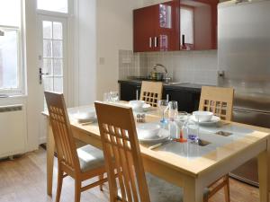 a kitchen with a wooden table with chairs and a dining room at Viewington Lodge in Ballater
