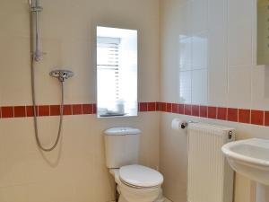 a bathroom with a toilet and a sink at Plum Tree Cottage in Kirkbymoorside +4 photos