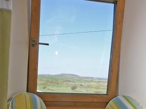 a glass door with a view of a field at Cairndoon Steading Whithorn in Carlton +7 photos