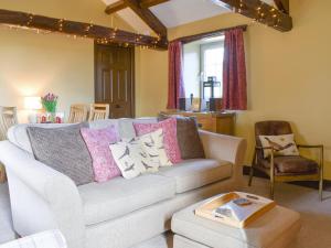 a living room with a couch and a table at Timbessie Barn in Carperby