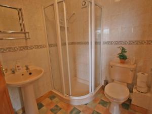 a bathroom with a shower and a toilet and a sink at Humbleton Falls in Wooler