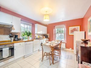 a kitchen with a table and chairs in it at Rhoda's Cottage in Strachur