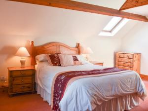 a bedroom with a large bed with a wooden headboard at Ricann - Ukc4244 in Lanreath +17 photos