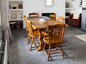 a wooden table and chairs in a living room at Ivydene Cottage in Cromarty