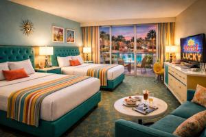 a hotel room with two beds and a television at lucky hotel in Chandīgarh