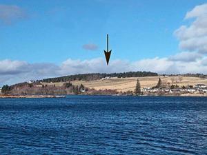 a kite flying over a large body of water at Reid's Cottage in Lairg +2 photos