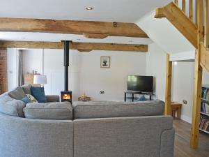 a living room with a couch and a tv at The Granary Uk13197 in Butterwick