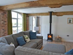 a living room with a couch and a fireplace at The Granary Uk13197 in Butterwick