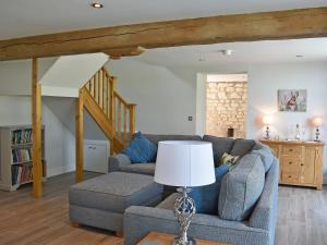 a living room with two couches and a table with a lamp at The Granary Uk13197 in Butterwick