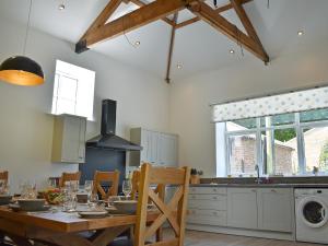 a kitchen with a wooden table and a dining room at The Granary Uk13197 in Butterwick +28 photos