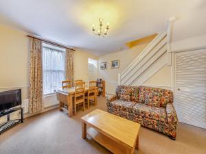 a living room with a couch and a table at Tweed Cottage in Alnwick