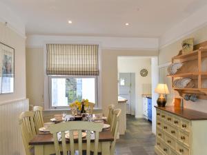a kitchen and dining room with a table and chairs at Sea Star Cottage in Fowey