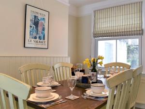 a dining room with a table with chairs and a tableablish at Sea Star Cottage in Fowey