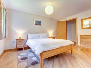 a bedroom with a large bed with two night stands at 14 Red Rock Apartments in Dawlish Warren +7 photos